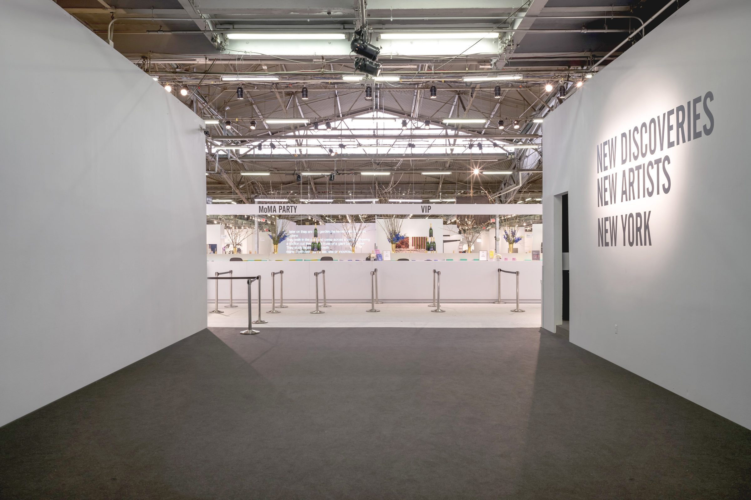 The Armory Show — fair entrance with &lsquo;New Discoveries, New Artists, New York&rsquo; signage wall