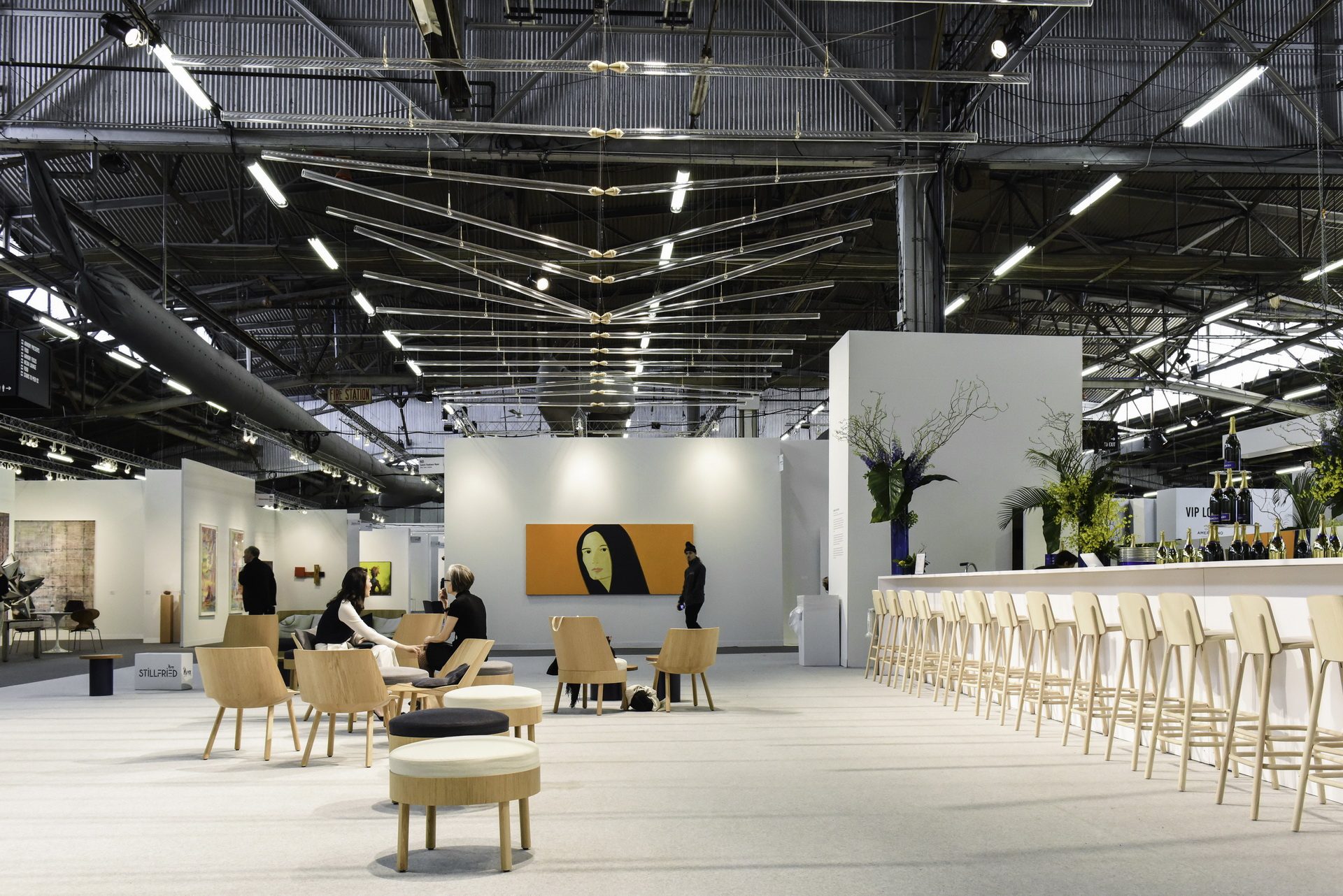The Armory Show — VIP lounge with bar, lounge seating and overhead light installation