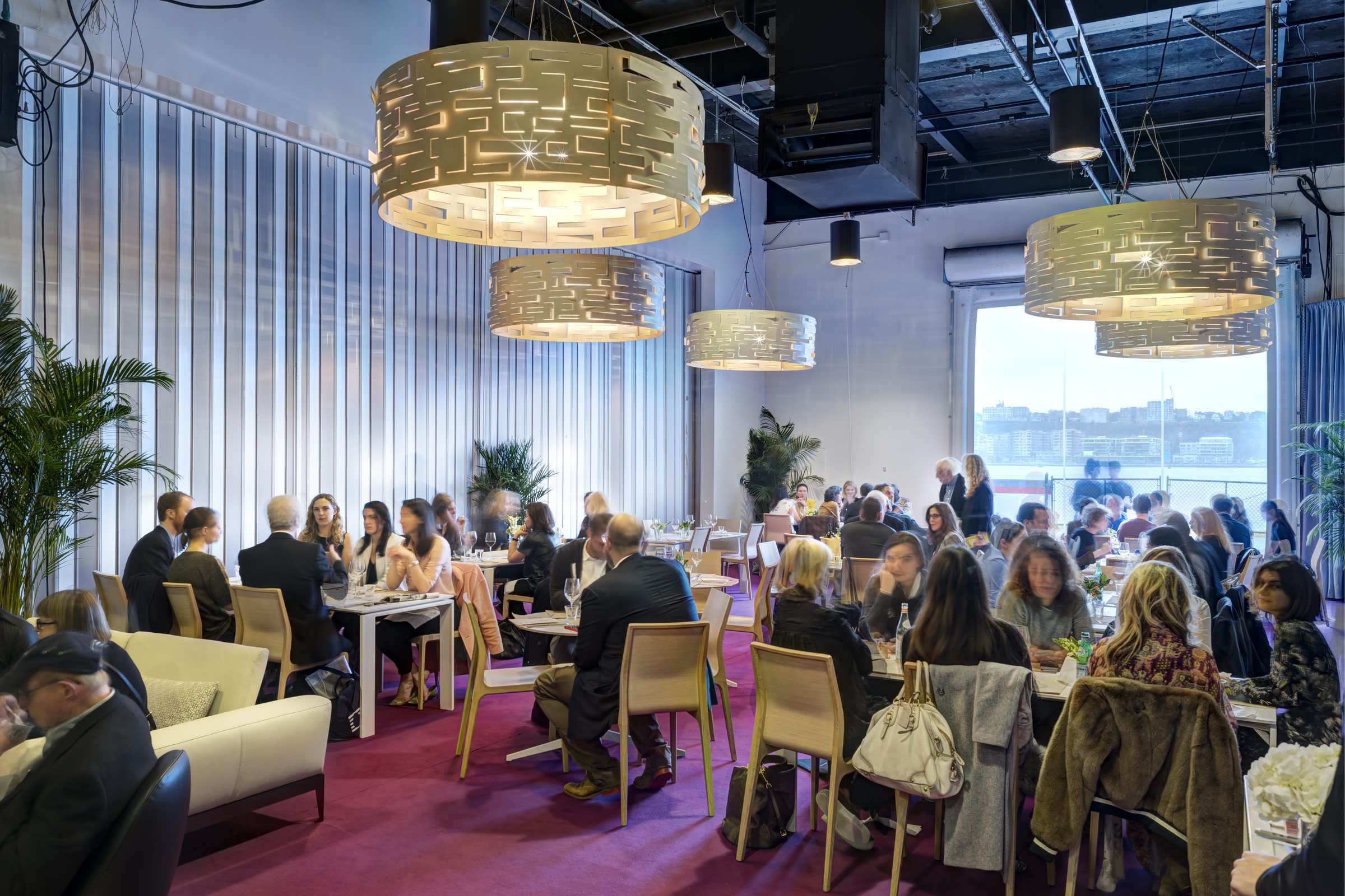 The Armory Show — VIP restaurant with pink carpet and perforated pendant lighting