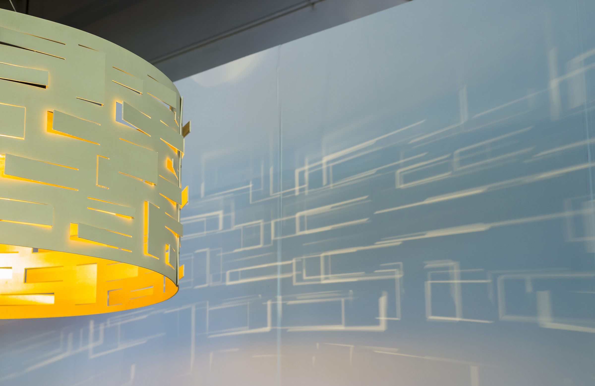 The Armory Show — detail of a perforated pendant lampshade against the riverfront glass